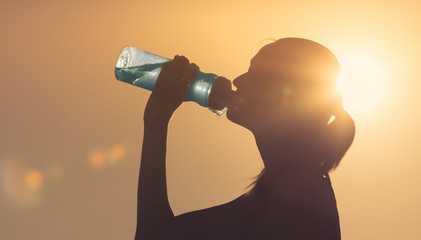 Woman drinking bottle of water outdoors - obrazy, fototapety, plakaty