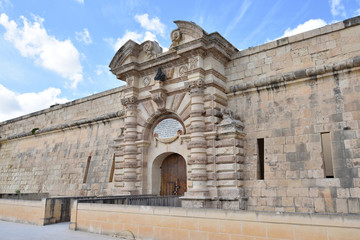 Fort Manoel is a historic landmark at the Manoel island in the Mediterranian sea, near Gzira town, Malta. View on main gate - 303932602