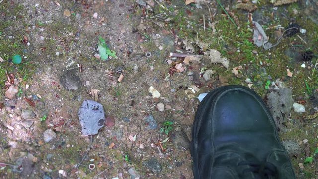 Ants go on surface of path next to man's shoes - (4K)
