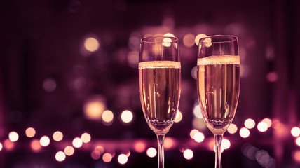 Two champagne drinks a colorful lights. 