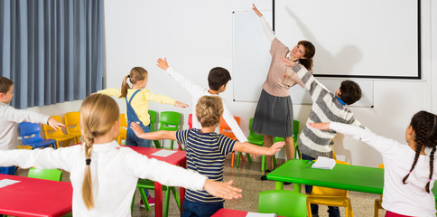 Teacher conducting warm-up with pupils