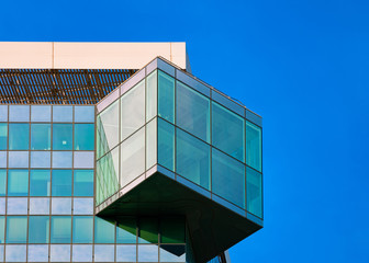 Glass Abstract Business office building architecture in Modern City in Vienna of Austria. Urban corporate skyscraper exterior and skyline. Blue windows design