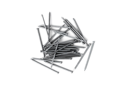 pile of metal nails isolated on white background, silver color glitting and reflecting in the light