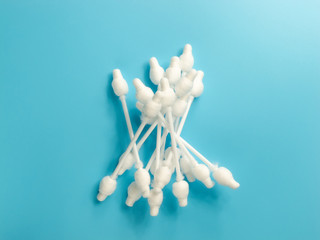 cotton buds close-up on a light blue background, for children, hygiene and ear cleaning, cotton swab