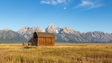 A view of a deserted wooden barn on Mormon row in Grand Teton National Park at sunrise