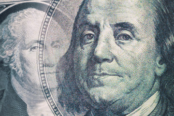 Finance background. Combined image of Benjamin Franklin and George Washington portraits on the US 100 and 1 dollar bill. Macro shot