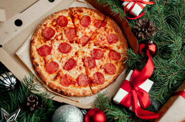 Christmas pepperoni pizza with Christmas decorations, gift, spruce, toys