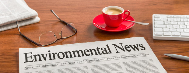 A newspaper on a wooden desk - Environmental News