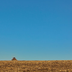 Agricultural Landscape. Tractor working on the field.