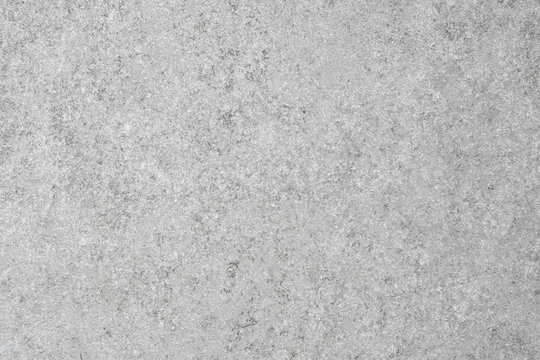 Close up of light grey slate tile background with speckled design.
