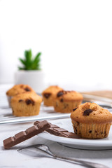 Delicious chocolate muffins on white background