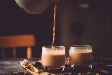 Masala tea ( Masala chai). A traditional hot drink in India and South Asia. Black tea with milk and spices - obrazy, fototapety, plakaty