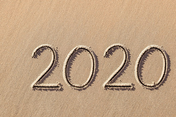 2020 year written on the beach sand
