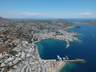 MYKONOS, GREECE : aerial view on the island and port side at sun weather