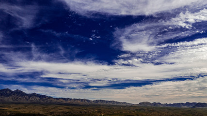 Sunset, aerial landscapes of Santa Rita Mountains from above Tubac, Arizona with warm , golden plains, purple mountains, blue sky with colorful clouds on a Fall day 