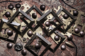 Composition of brass parts, rivets and gears of different sizes. Steampunk background.