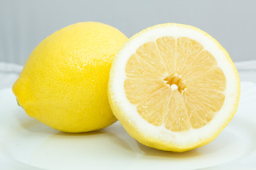 still life a whole lemon and half of it close up