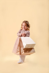 Small fashion girl . happy shopping girl runs with full bags and laughs. black Friday discount. cyber Monday. Present and gifts buy. summer sales. copy space.