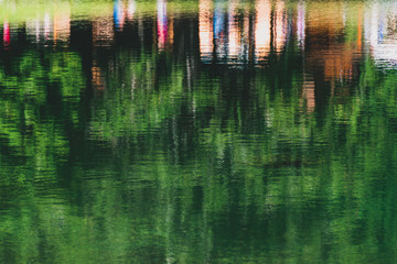 reflection on the water of people on the edge of a mountain lake