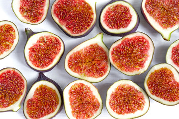 Pattern of sliced figs on a white background. Close-up photo of chopped figs. The source of iron and potassium in the body