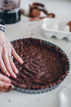 Woman Using Hands To Fill Pie Crust Tin