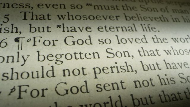 For God so loved the world that he gave his only begotten son... tracking shot of the scripture verse John 3:16.  An additional shot of the illustration of the Crucifixion of Jesus Christ is included.