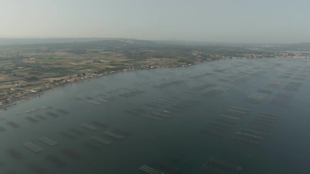 Aerial shot of oyster farms near Sete city on lake Etang de Thau, Mediterranean, France 