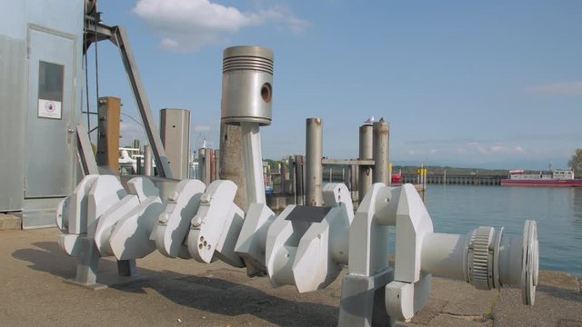 The engine crankshaft piston part ship boat vessel in port blue sky background truck camera movement