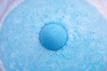 Blue bath bomb foaming in water