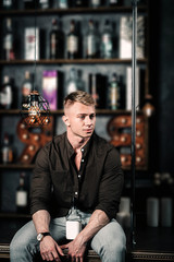 handsome sexy man at the bar counter in a shirt.