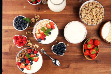 Tasty homemade granola served on table. Healthy breakfast with a bowl of oatmeal with banana, blueberries, strawberries and healthy food for Breakfast