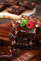 chocolate brownie cake dessert with raspberries and spices on a wooden background.