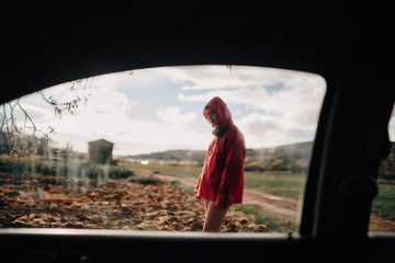 Fototapeta premium View from inside a young woman car outside in rainy day