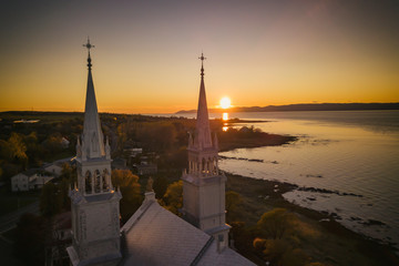 Aerial view of a church bell tower with beautiful sunset