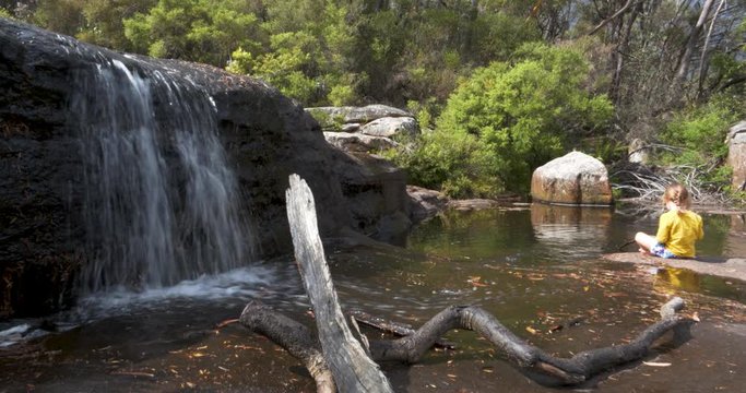 Carrington Falls nellies Glen small waterfall young girl child playing in water pond