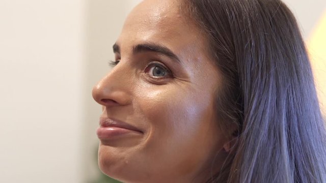 Professional make up artist gently touching to model's face with her brush