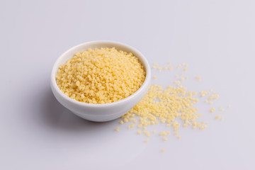 Dry couscous isolated on white background, soft light, copy space.