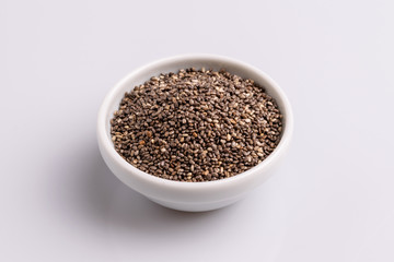 Chia seeds  isolated on white background, angle view, copy space, studio shot, soft light. Latin name (Salvia hispanica).
