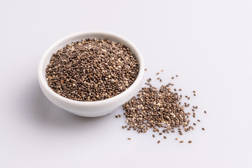 Chia seeds  isolated on white background, angle view, copy space, studio shot, soft light. Latin name (Salvia hispanica).