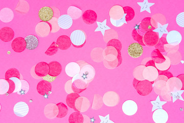 Multicolor pink, gold and white confetti on the bold pink background, holiday celebration backdrop, Flat lay style