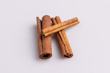 Cinnamon sticks isolated on white background, copy space, studio shot, soft light, top view.  Latin name  Cinnamomum cassia