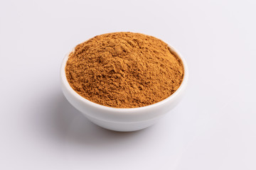 Cinnamon powder isolated on white background, copy space, studio shot, soft light, top view.  Latin name  Cinnamomum cassia