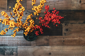 Top view of beautiful yellow and orange berries on rustic wood background with blank space for copy