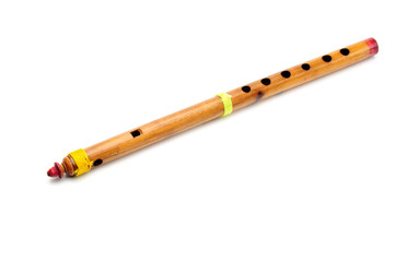 Bamboo wind instrument indian flute on white background © moviephoto