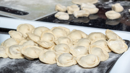 Fototapeta na wymiar We cook dumplings, minced meat, dough, food.