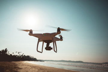 Drone flying in the air under at seaside