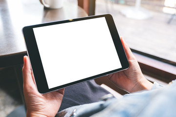 Mockup image of a woman holding black tablet with white blank screen