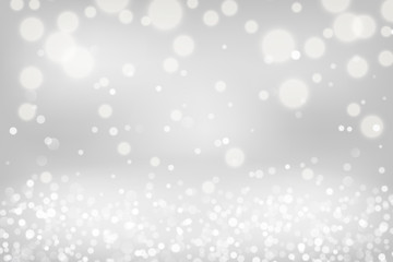 Fototapeta na wymiar Silver bokeh background. Christmas glowing lights with sparkles. Holiday decorative effect.
