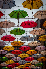 Fototapeta na wymiar Colorful umbrellas over the city street in Dublin. Concept of joyful mood.