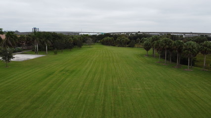 Fototapeta premium a drone shot overloking a feild with some trees and a highway in the background
